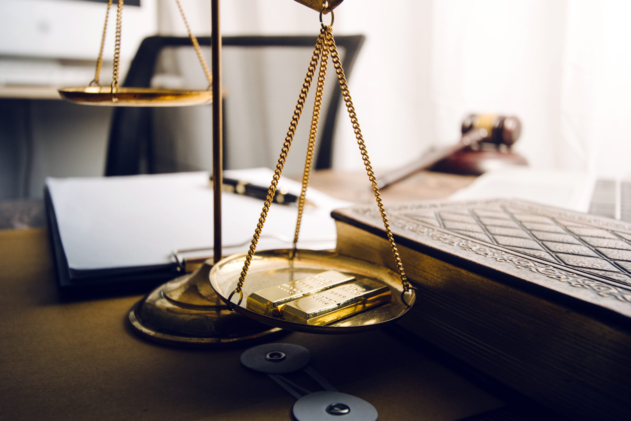 Business and lawyers discussing contract papers with brass scale on desk in office. Law, legal services, advice, justice and law concept picture with film grain effect